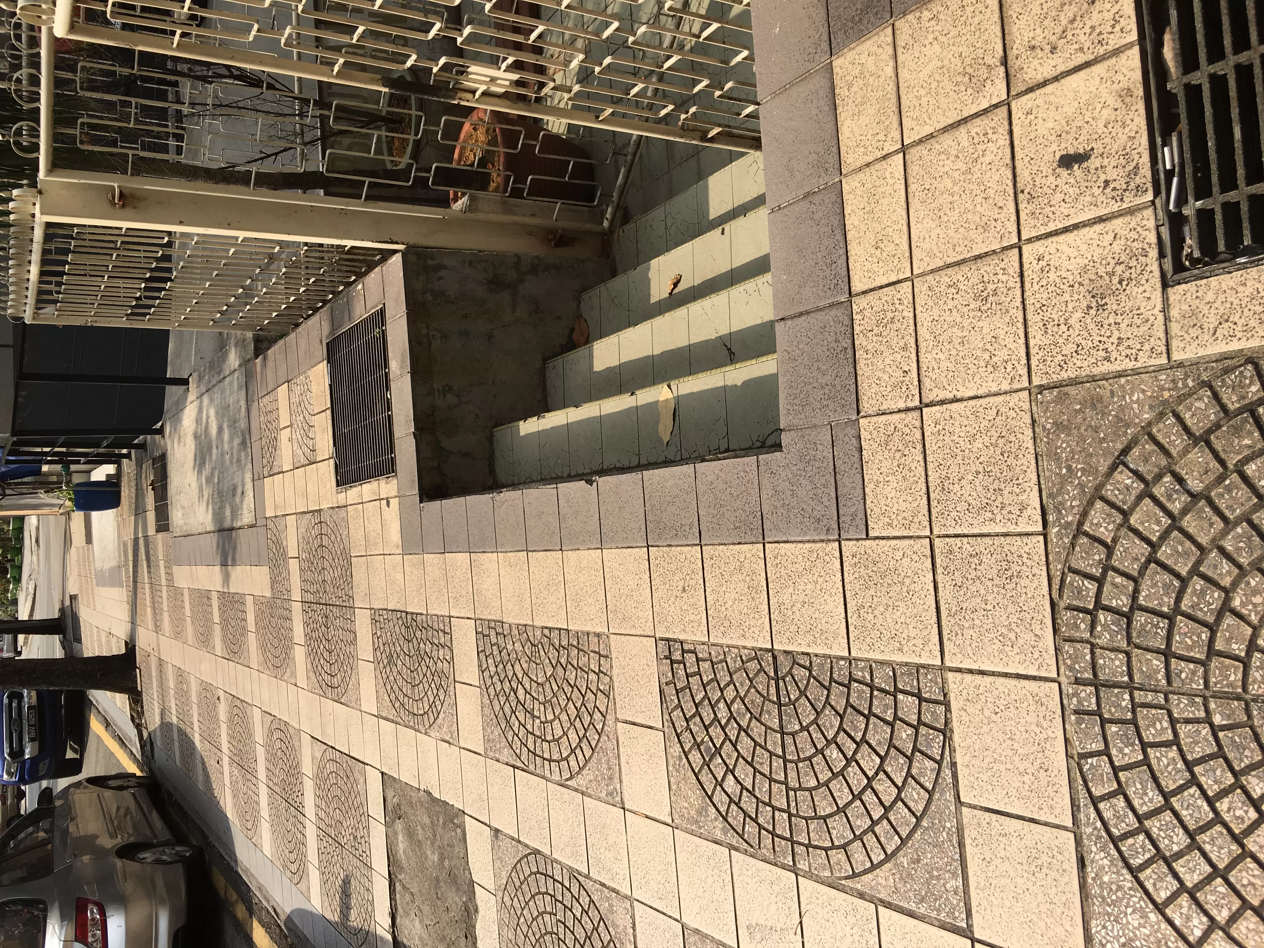 A dangerous set of steps leaving a gap for pedestrians to fall into, ona public footpath.