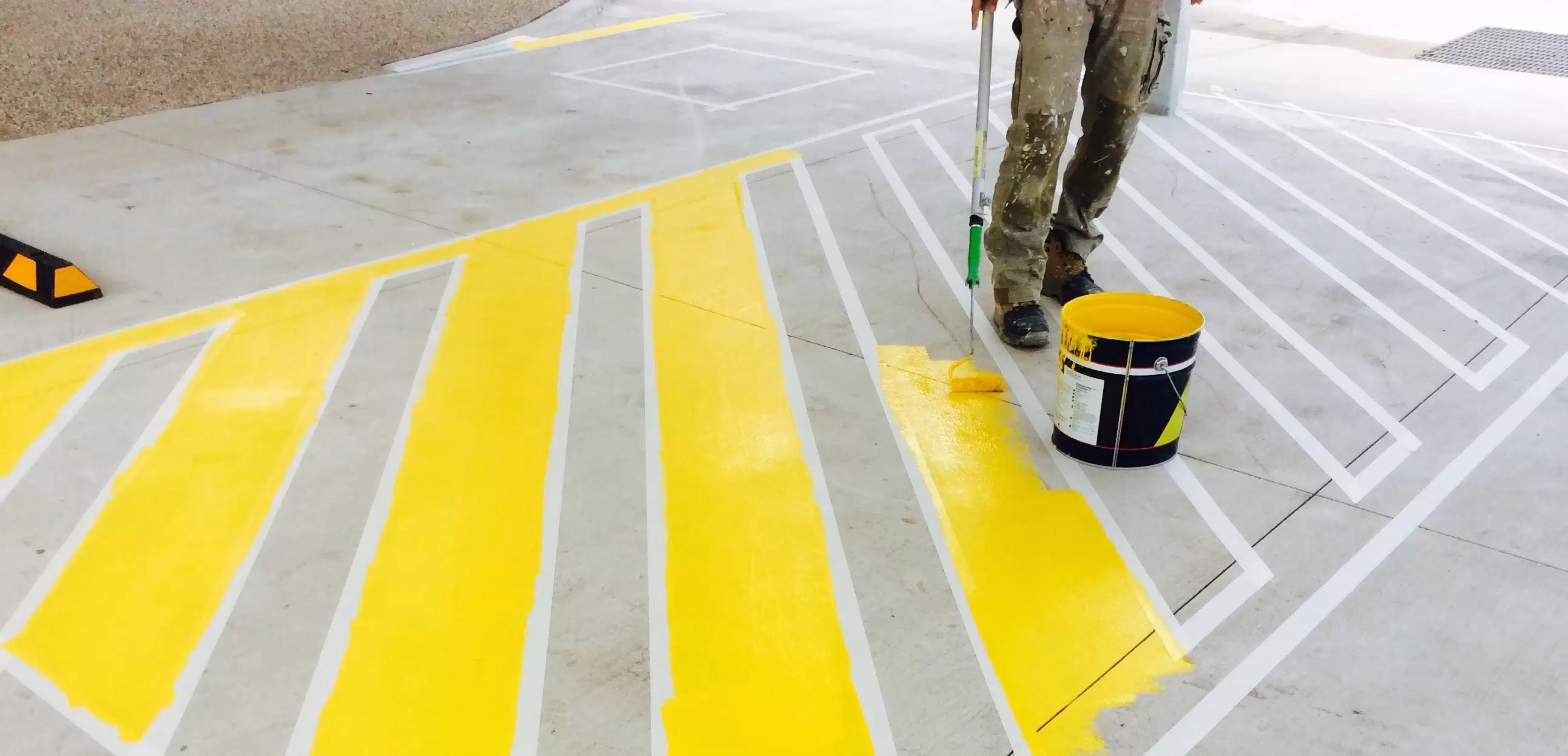 A man painting high luminance contrast lines